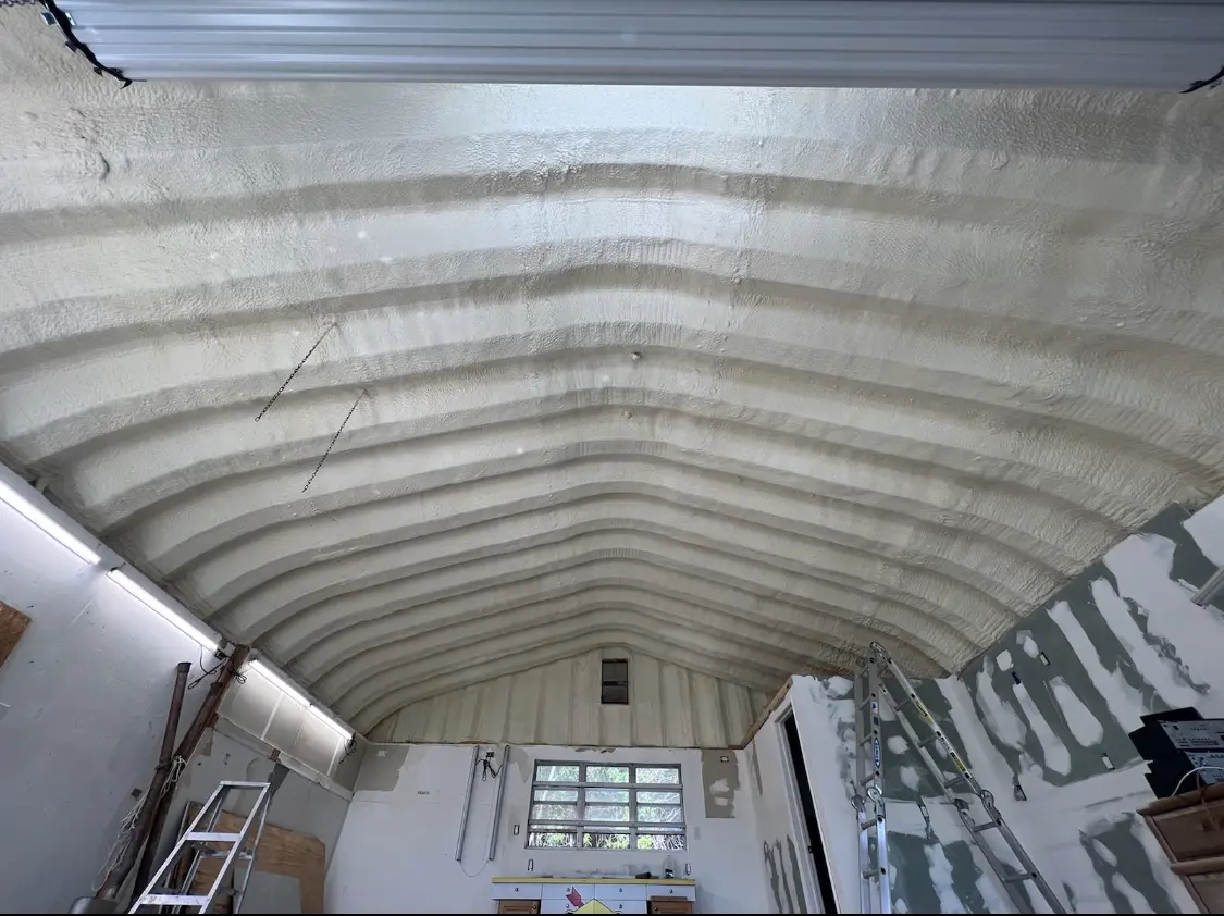Spray polyurethane foam applied to the underside of a metal roof deck in Dunedin